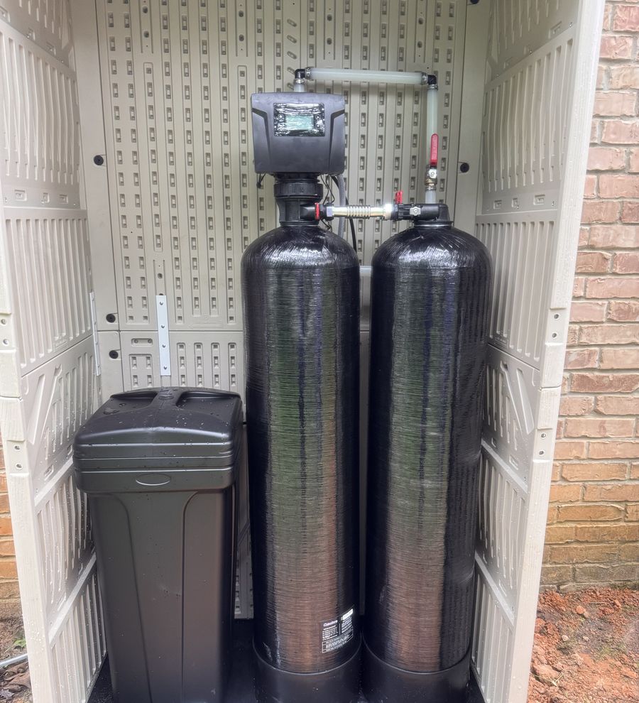 Twin-tank whole-home water treatment system and brine tank installed in a weatherproof outdoor enclosure by Rose City Water Filtration